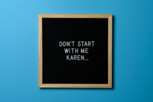 Funny text on a black letter board with wooden frame against a blue background, highlighting humor and casual tone.