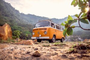 A classic orange Volkswagen van parked in a picturesque setting in Alegría, El Salvador.